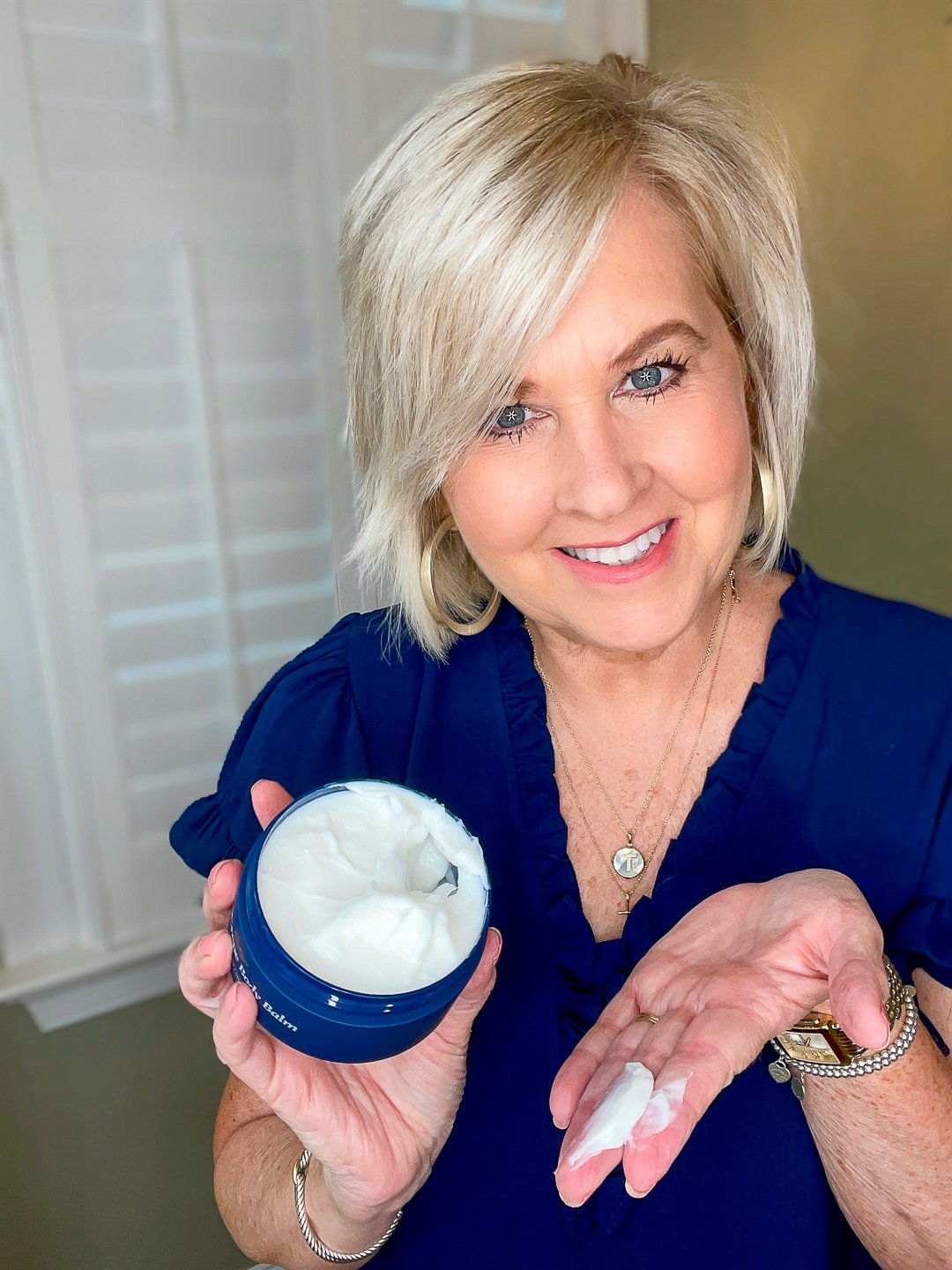 Over 40 Fashion Blogger, Tania Stephens is wearing a blue top and trying City Beauty's Inviscrepe Body Balm 2