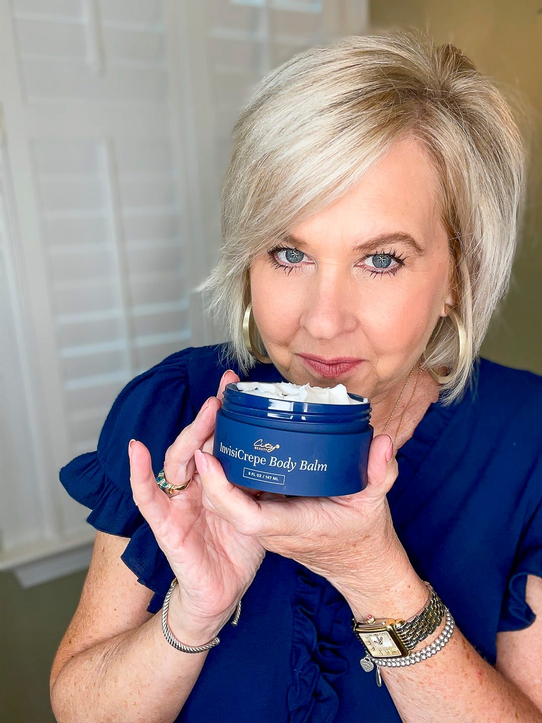 Over 40 Fashion Blogger, Tania Stephens is wearing a blue top and trying City Beauty's Inviscrepe Body Balm10