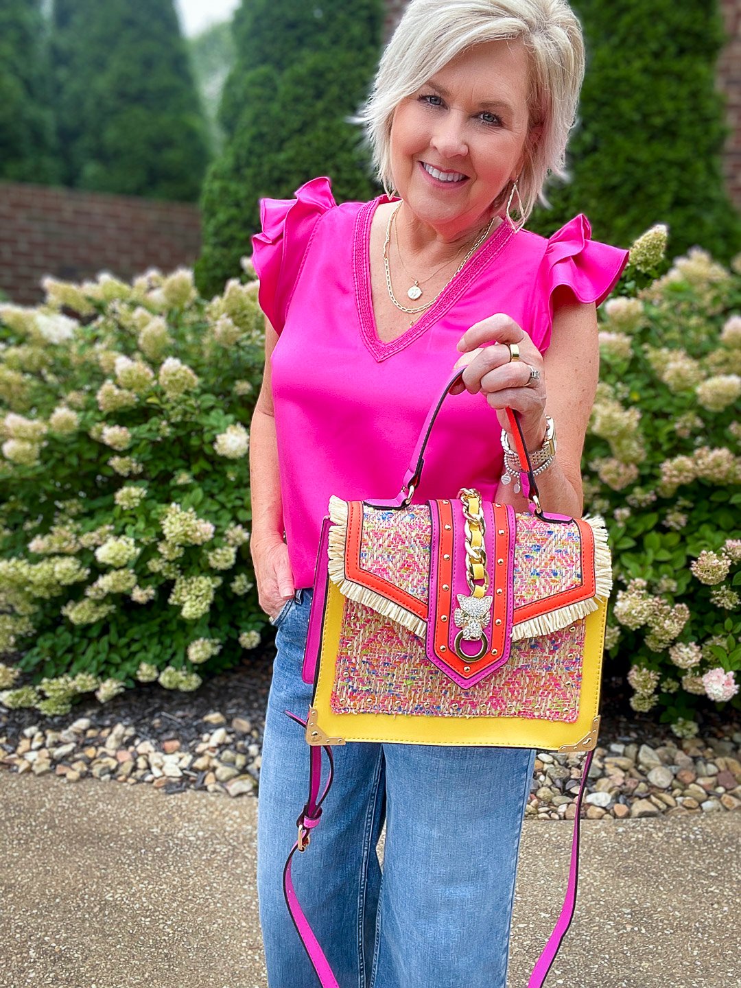 Over 40 Fashion Blogger, Tania Stephens is styling wide leg jeans with a pink ruffled top12