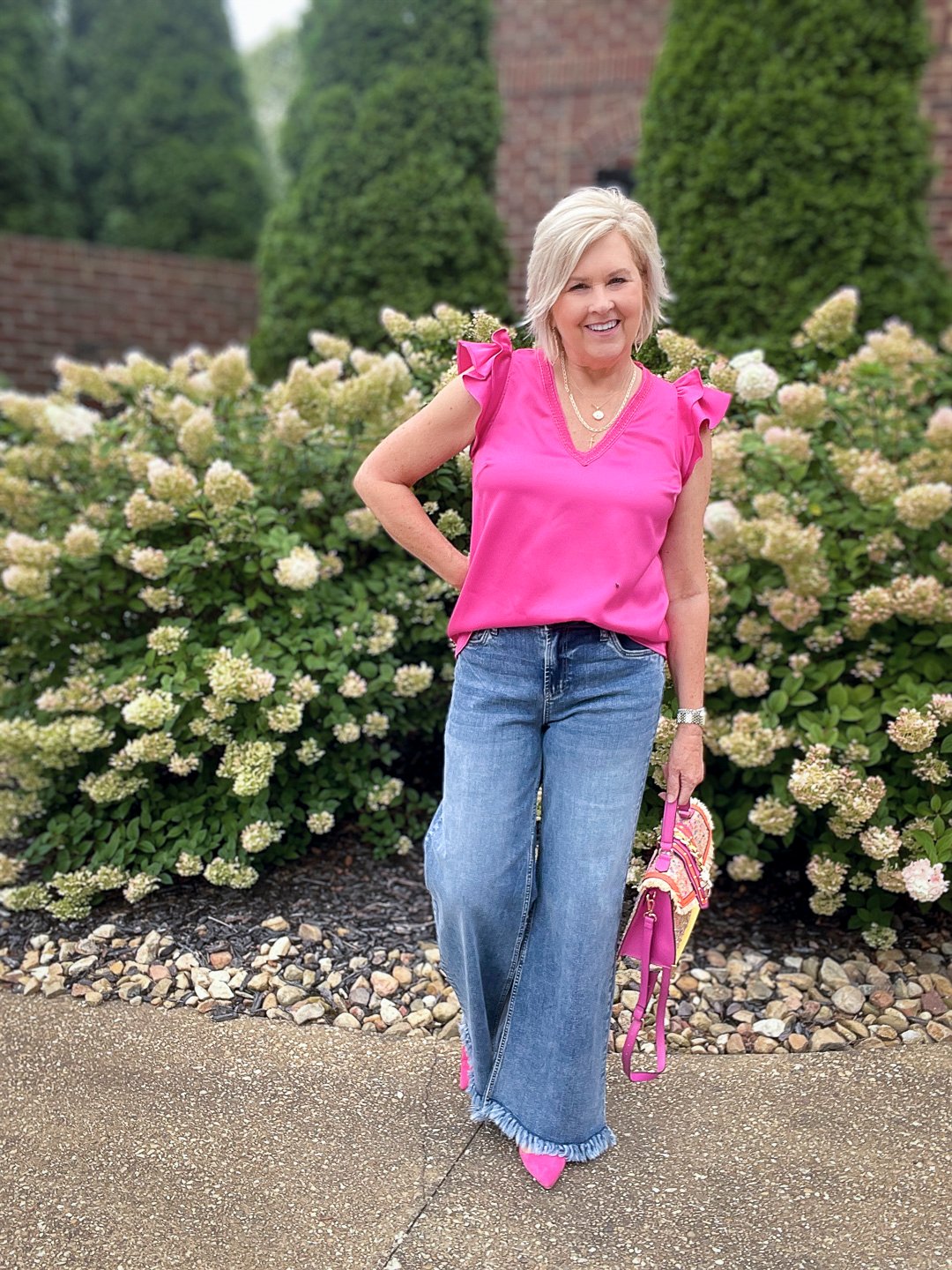 Over 40 Fashion Blogger, Tania Stephens is styling wide leg jeans with a pink ruffled top7