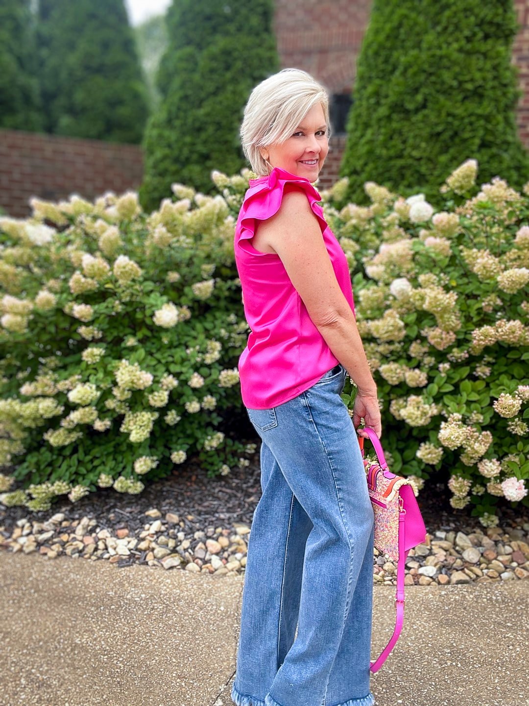 Over 40 Fashion Blogger, Tania Stephens is styling wide leg jeans with a pink ruffled top15