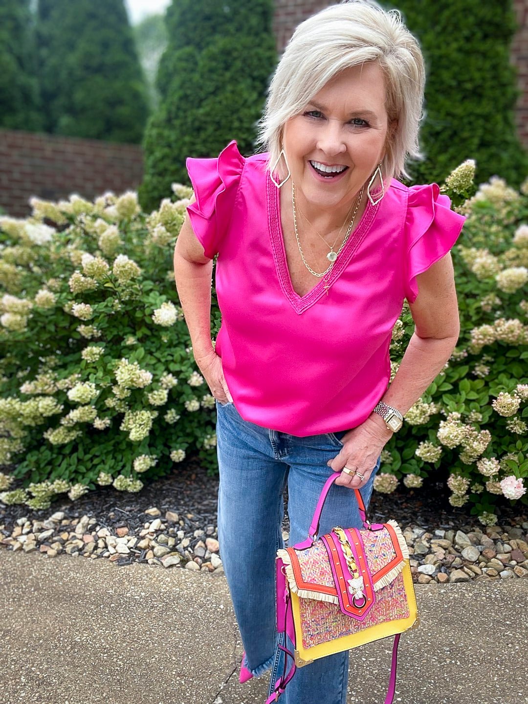 Over 40 Fashion Blogger, Tania Stephens is styling wide leg jeans with a pink ruffled top21