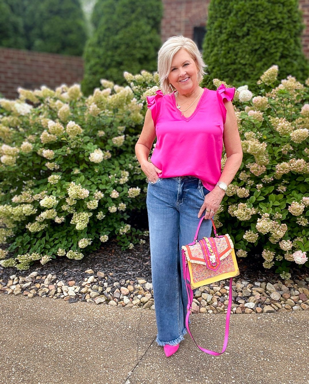 Over 40 Fashion Blogger, Tania Stephens is styling wide leg jeans with a pink ruffled top19