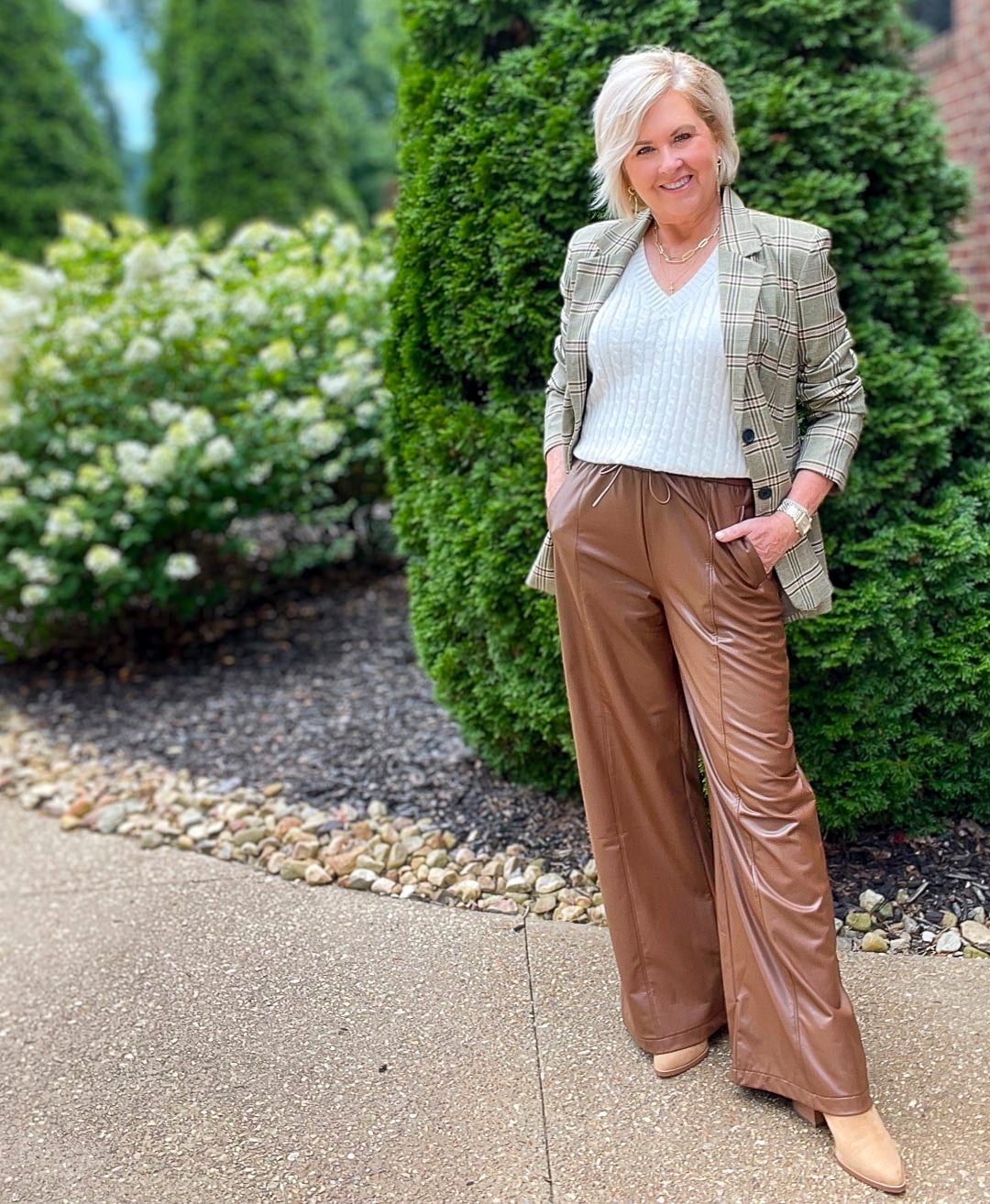Over 40 Fashion Blogger, Tania Stephens is styling brown faux leather wide leg pant with a cream sweater and a plaid blazer4