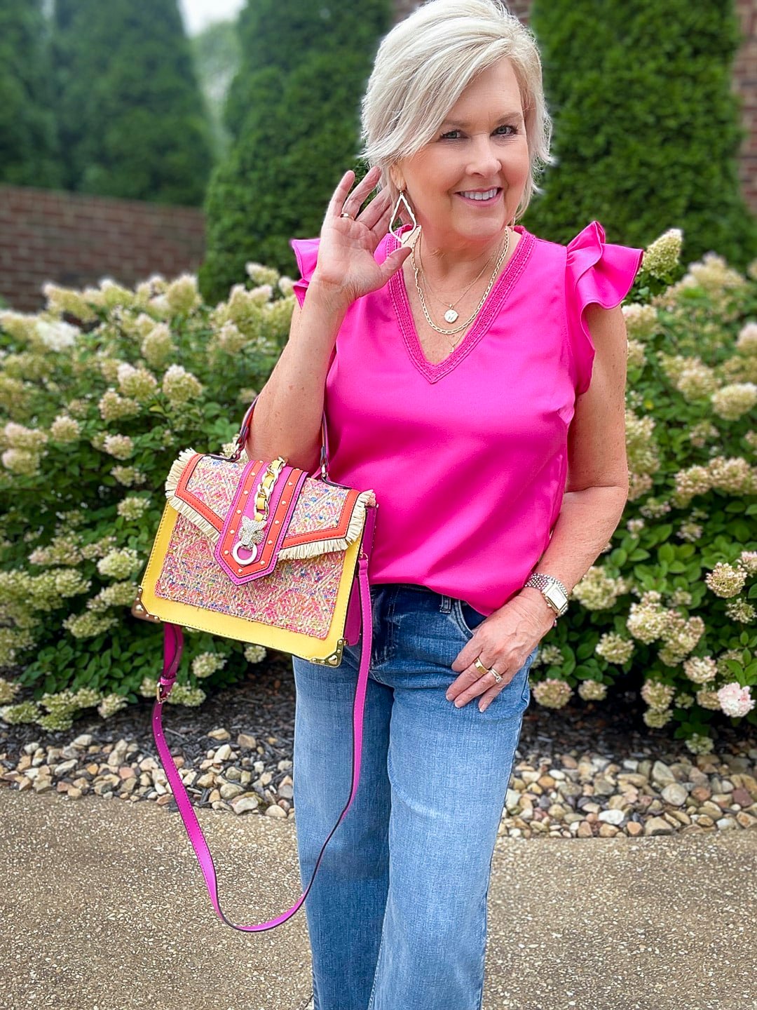 Over 40 Fashion Blogger, Tania Stephens is styling wide leg jeans with a pink ruffled top13