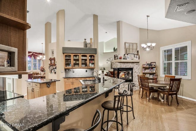 The large open kitchen opens to the gathering room and features granite countertops, a center island, a breakfast bar and a cozy nook area overlooking the outdoor living space.