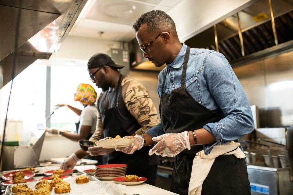 Baobab Fare co-owner Hamissi Mamba prepares a dish during a Detroit Free Press Top 10 Takeover dinner, Tuesday, July 19, 2022.