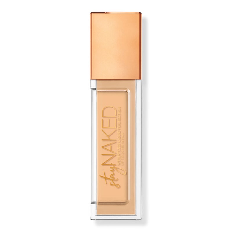 A clear sqaure foundation bottle with gold cap of the Urban Decay Stay Naked Weightless Liquid Foundation on a white background