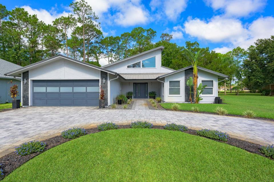 This meticulously updated and maintained home, with a modern look, well-manicured landscape and the brick-paver circular driveway, backs up to the Cypress Knoll Golf and Country Club in Palm Coast.