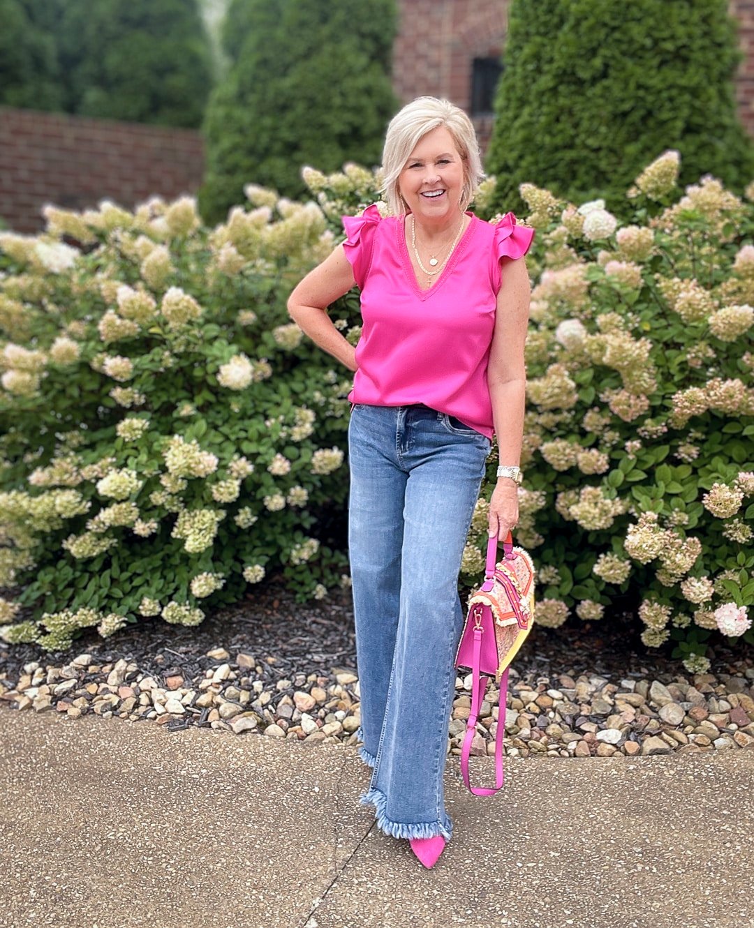 Over 40 Fashion Blogger, Tania Stephens is styling wide leg jeans with a pink ruffled top 6