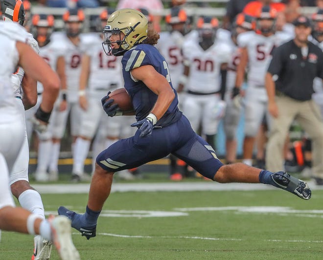 Hoban's Jayvian Crable runs for yardage after a first quarter catch against Erie Cathedral Prep quarterback Carter Barnes on Friday, Aug. 26, 2022 in Akron, Ohio, at Dowed Field.